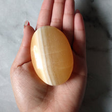 Load image into Gallery viewer, Orange Calcite Palm Stone